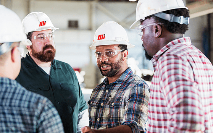 workers in hardhats in discussion