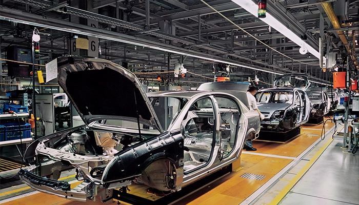 Car production line with unfinished cars in a row