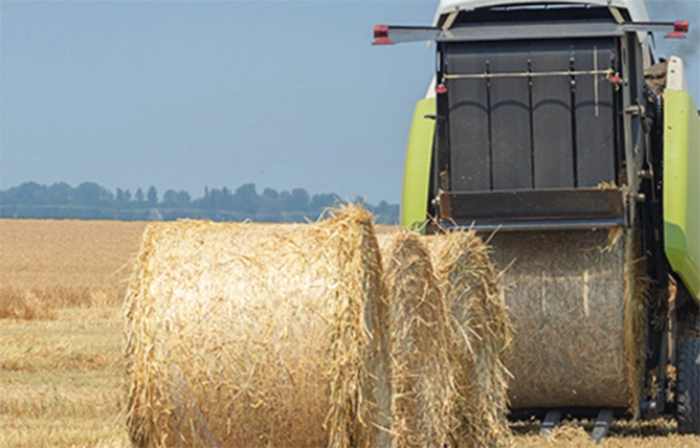 Large hay baler, baling hay on farm