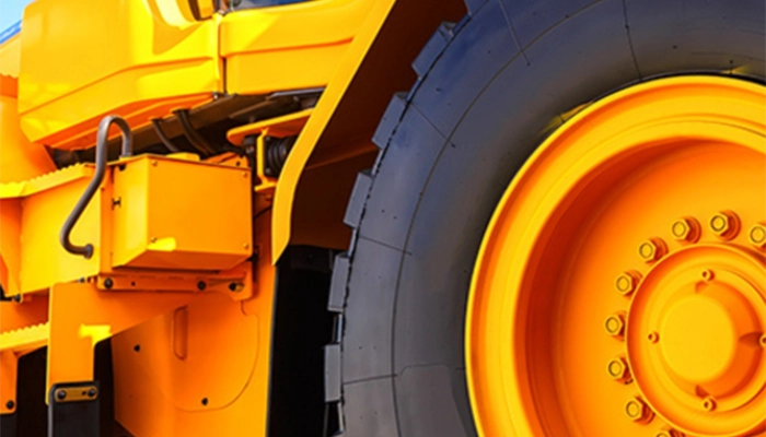 Close-up of large yellow bulldozers wheels