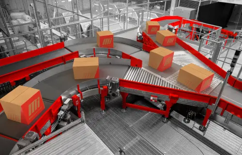 Aerial view of conveyor system with Motion labeled boxes, moving packages in distribution center