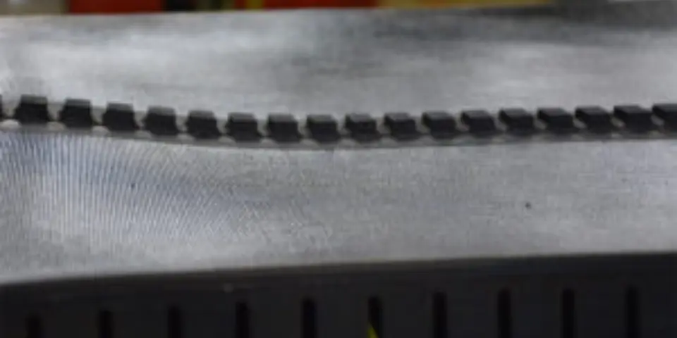 Close-up of a black v-guide belt sample