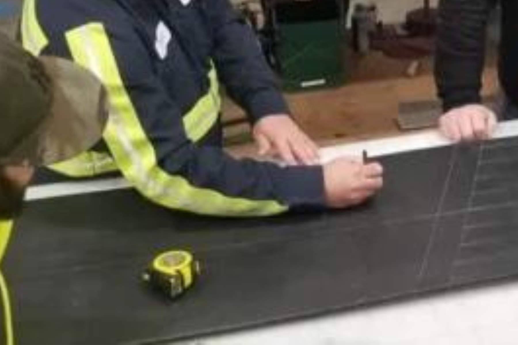 Team members work on splicing a conveyor belt